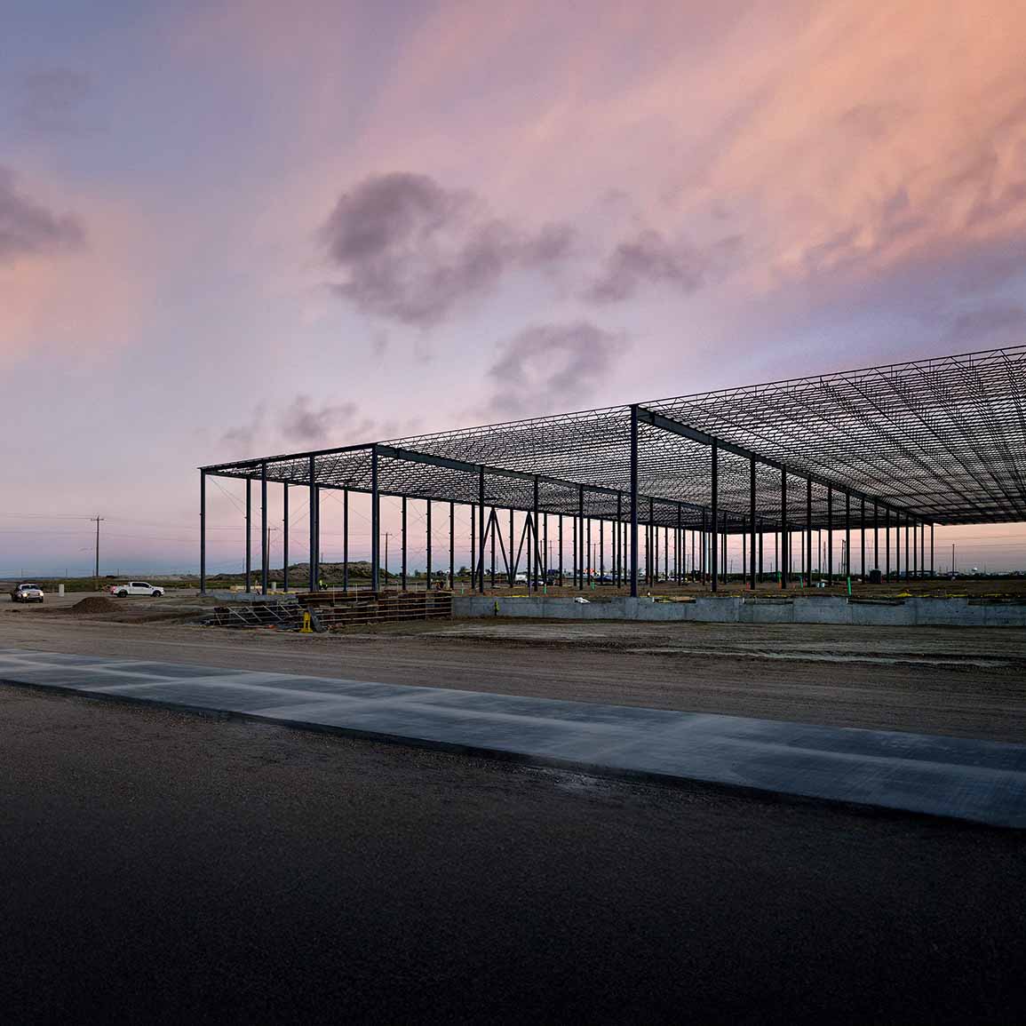 framing of a commercial construction project set under a sky at sunset 
