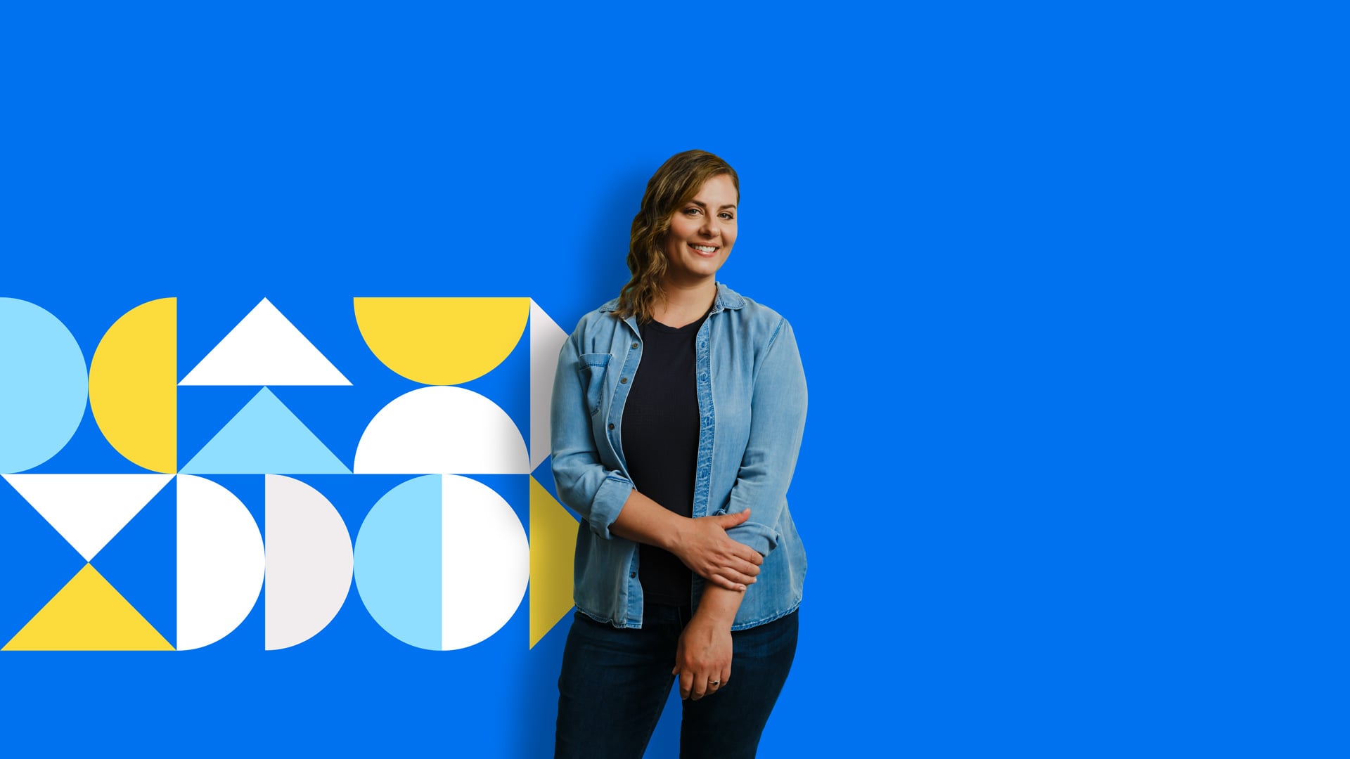 An Albertan stands in front of a blue background