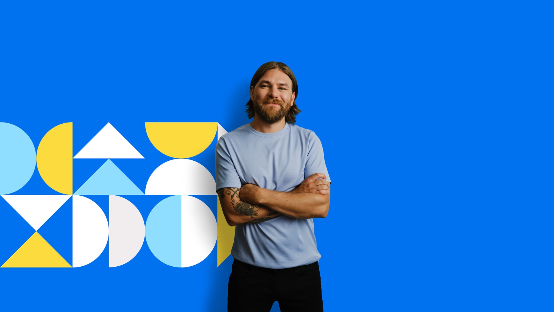 An Albertan stands in front of a blue background