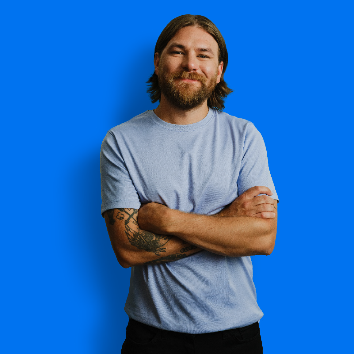 Albertan stands in front of a blue background