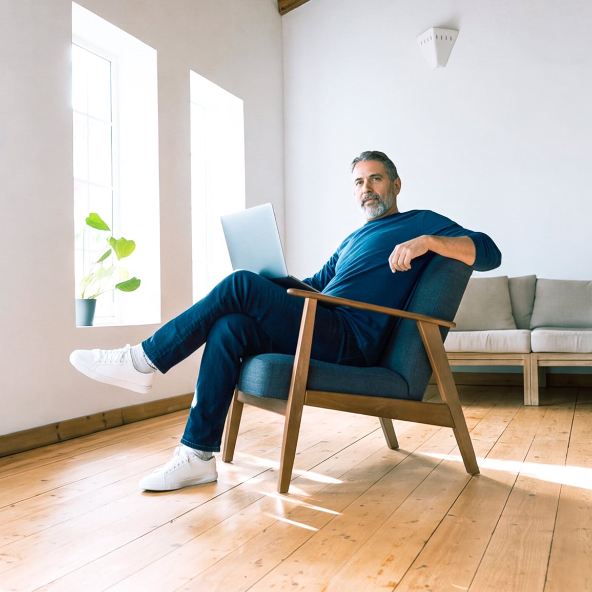 An Albertan sitting at home on a laptop purchasing a GIC
